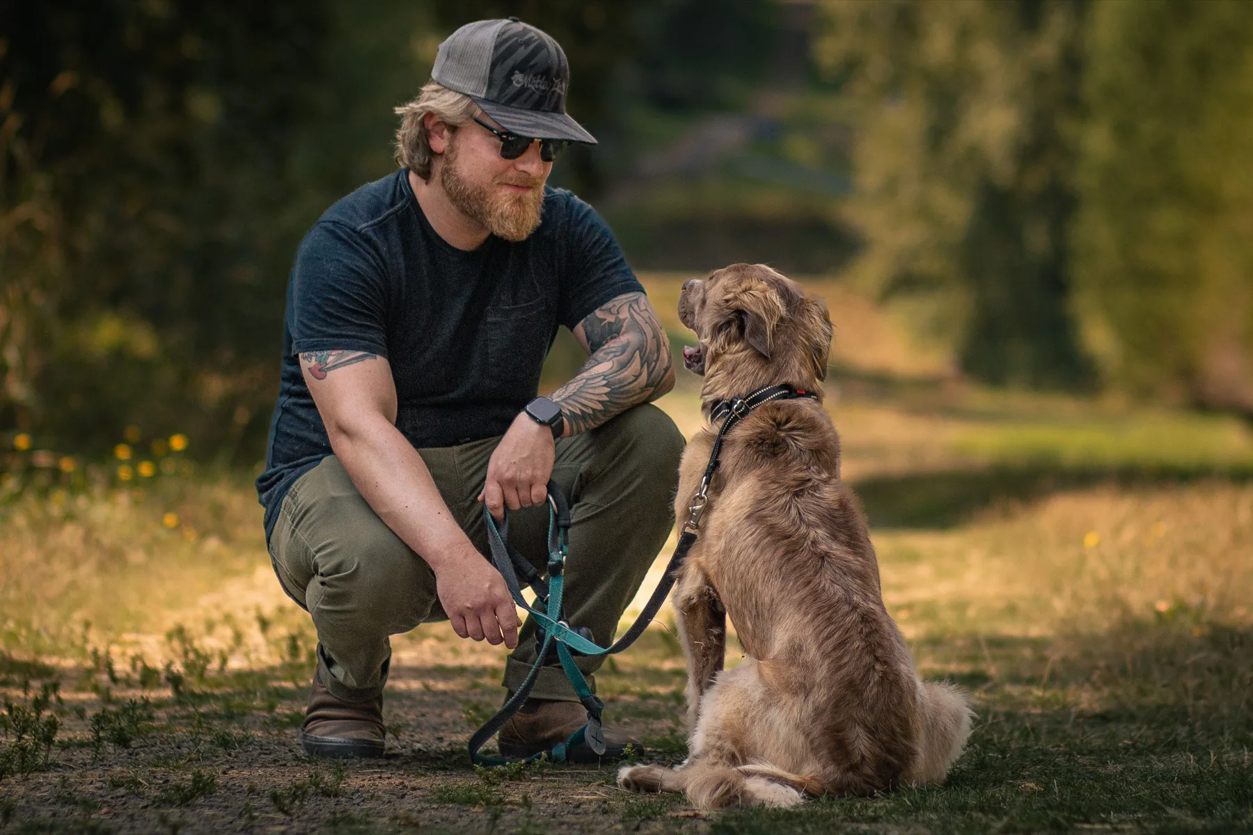 Corey Champagne outdoors with his dog Thor